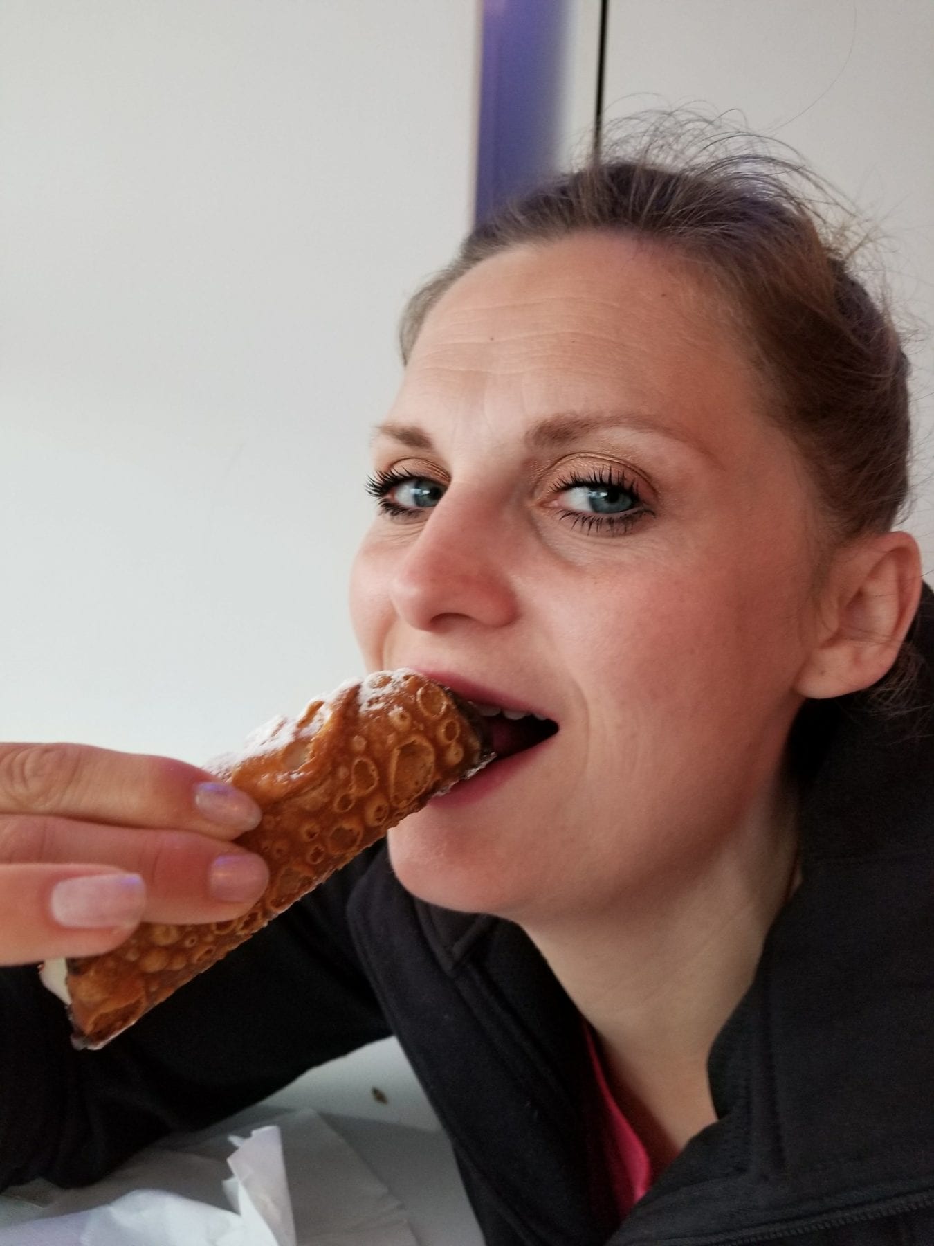 Eating a Canoli in Positano italy