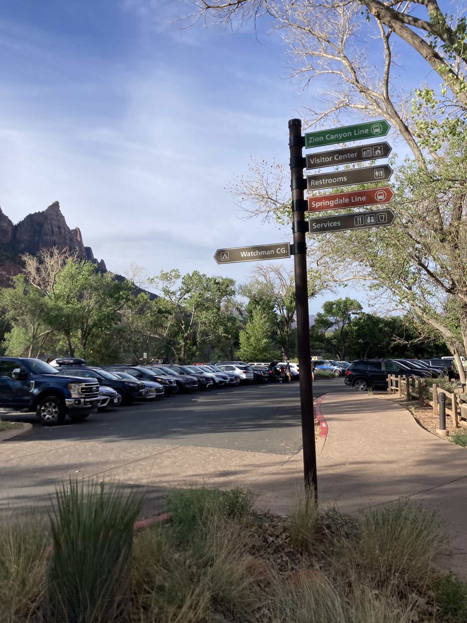 Visitor center garden with blooming flowers and trail signs
